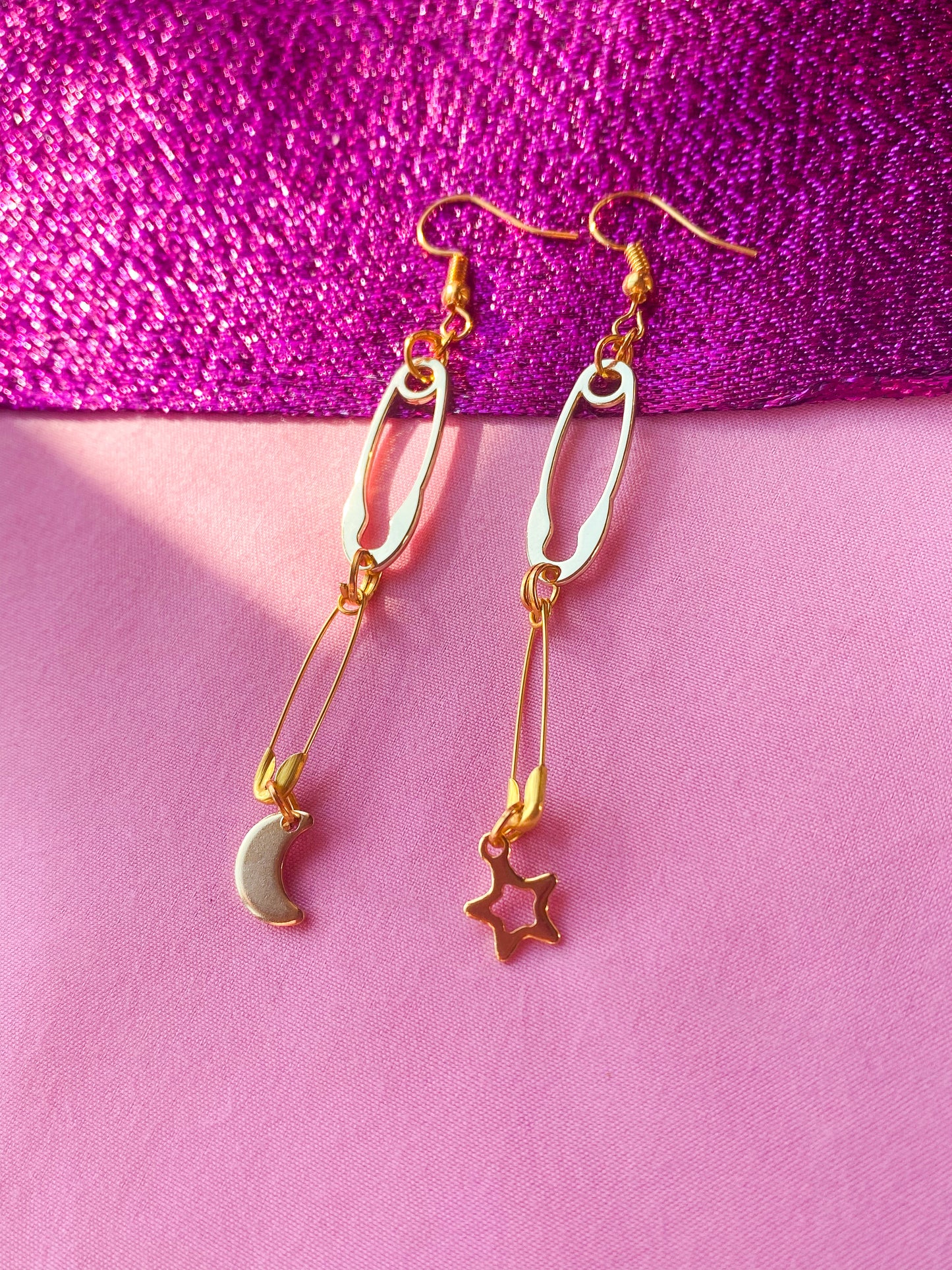 Gold safety pin with moon and star charm earrings