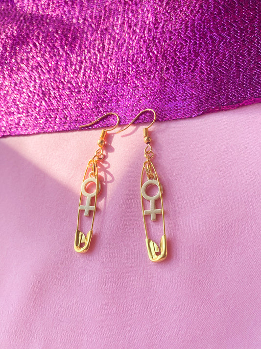 Gold safety pin and Venus charm earrings