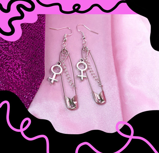 Safety pin earrings with Venus symbol charm