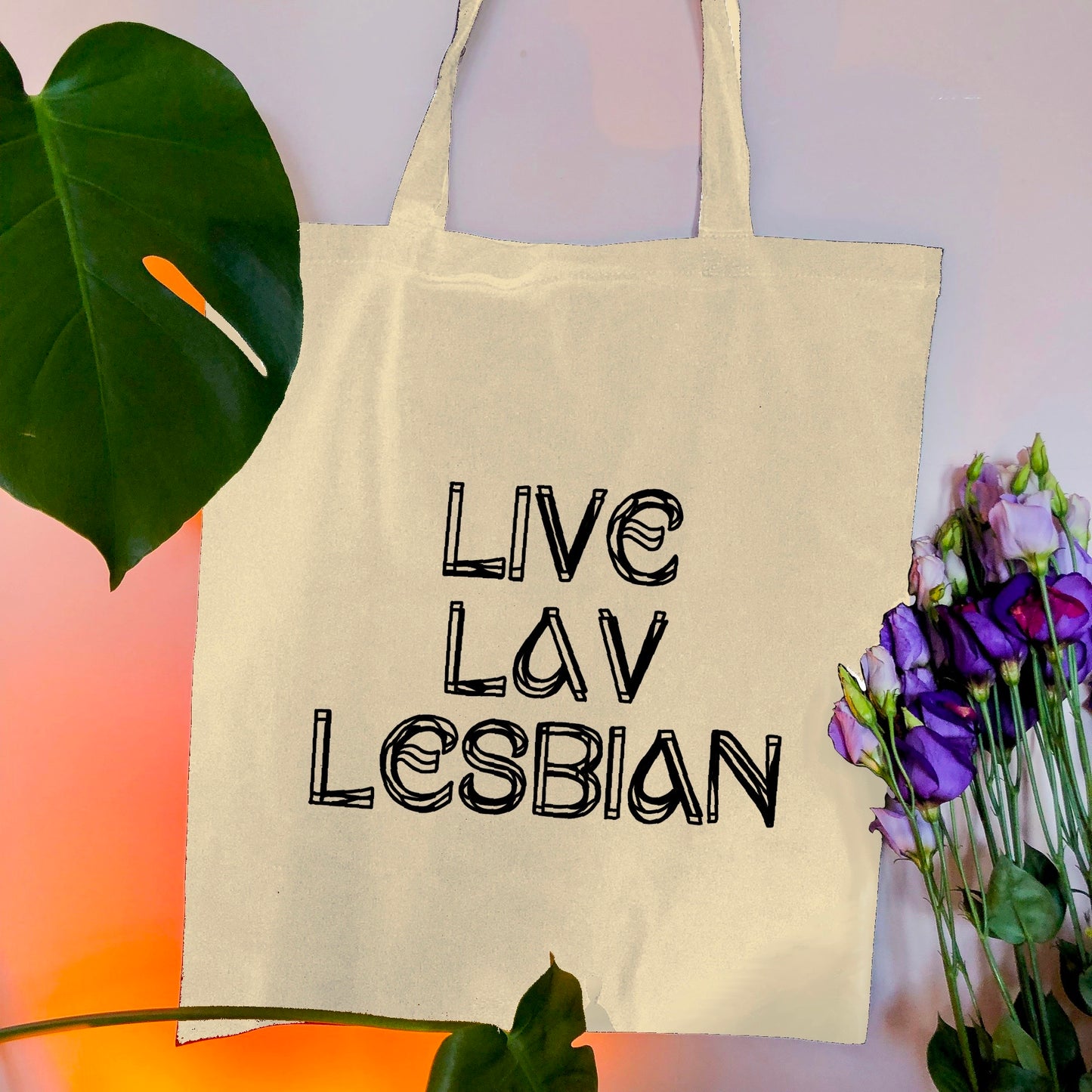Live Lav Lesbian, Beige tote bag with black vinyl text. Leftbians Collab with Lavender Rodriguez