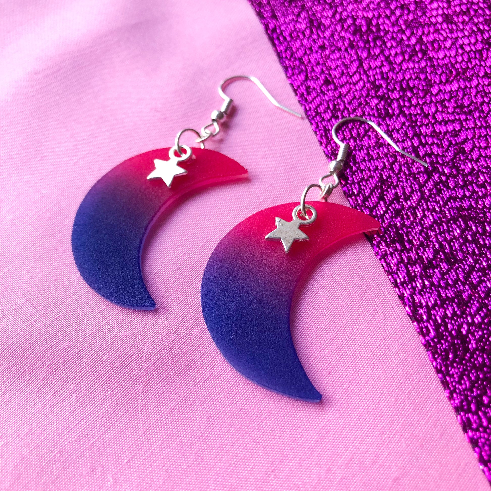 Crescent moon shrinky dink earrings in bisexual pride flag colours with a silver star charm at the top.