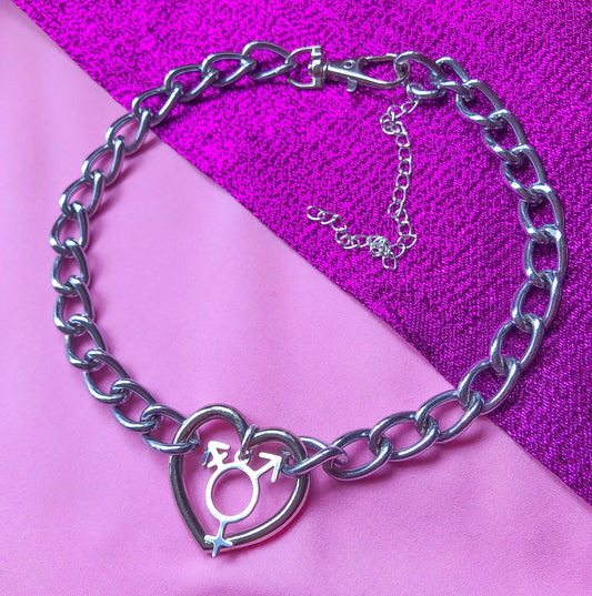 Chunky chain necklace with a love heart O ring in the middle, with a transgender symbol charm attached.
