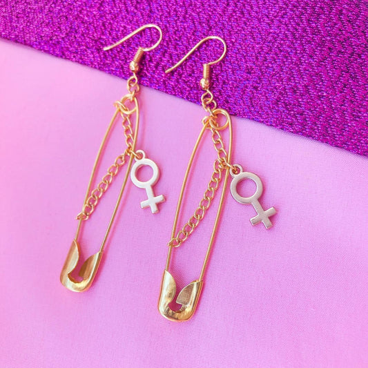 Gold safety pin earrings with chain and Venus charms