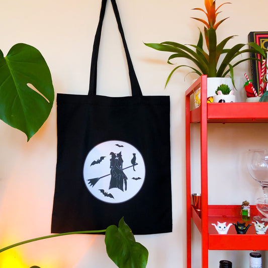 Gay witches on a broomstick, black tote bag